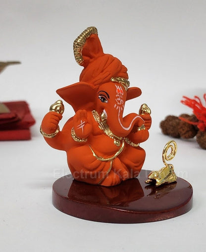 Orange Ganesha Idol with Gold Plated Mooshak